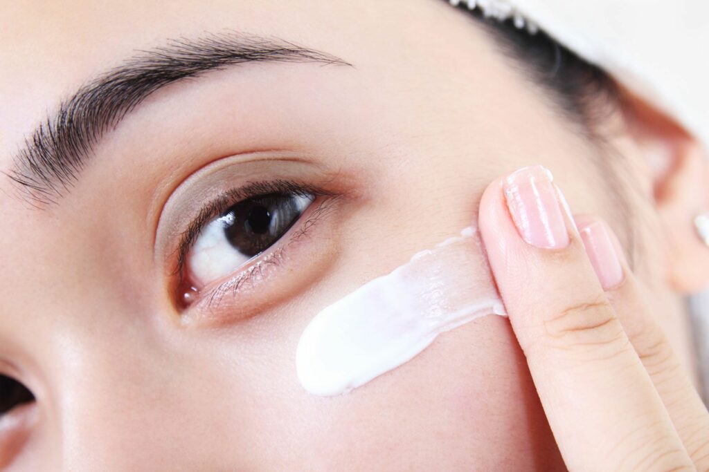 woman applying eye care solution