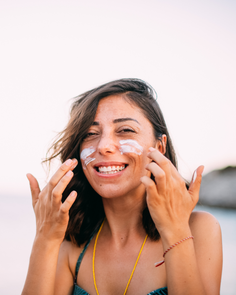 Someone applying natural sun shield for UV protection.
